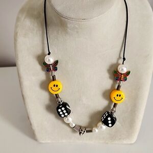 smile and skull and buttwrfly necklace